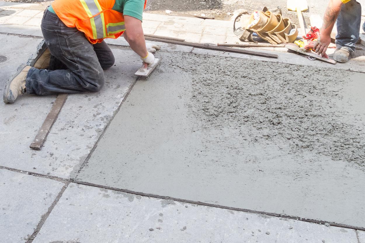 Concrete paving being screeded